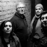 UZEDA | sPAZIO211 (TO) May be a black-and-white image of 3 people and brick wall