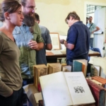 Mantova Libri Mappe Stampe X ed. May be an image of 4 people, people studying, book and text