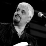 Firenze Suona Pino Daniele | Gran Concerto alla Limonaia Strozzi May be a black-and-white image of 1 person and guitar