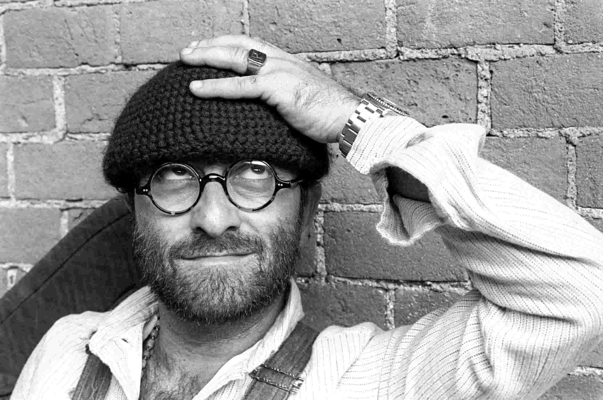 Ancona Suona Lucio Dalla | Gran Concerto al Teatro Sperimentale May be a black-and-white image of 1 person, beard, hat and glasses