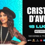 Cristina D’Avena feat Gem Boy Potrebbe essere un'immagine raffigurante 1 persona e il seguente testo "CRISTINA D'AVENA 18 LUGLIO RAFFO PARCOG G•NDAR TICKETS DISPONIBILISU VIVATICKET RAFFO 1m0w리l LANNSA Jasequerro tailoor italo itabus TPA6ИrE"